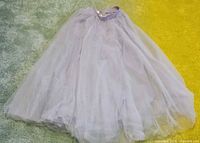 Full view of silver-gray tulle skirt spread on floor