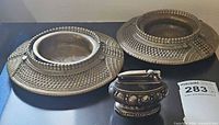 Lighter and both brass anklet ashtrays grouped together