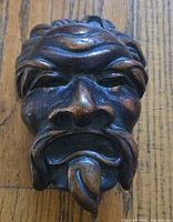 Front view of bronze face mask showing details