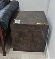 Overall view of cube side table beside leather sofa