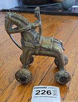 angled front view showing horse, rider and wheels