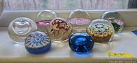 Group shot showing all eight paperweights for overview