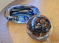 Front view of both paperweights showing shapes and coloration