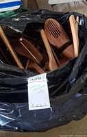 Bag filled with assorted wooden hangers and visible cedar shoe trees