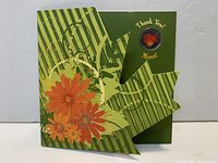 Front of folded display card showing floral graphics and coin inset