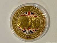 Reverse of gold-coloured 2015 One Crown coin in capsule, showing design details