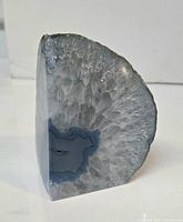 Front view showing polished face, blue banding, quartz crystal center