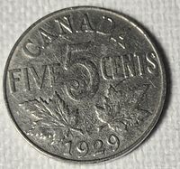 Reverse of 1929 Canadian five-cent nickel coin showing denomination, maple leaves and date