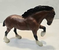 Left-side view of Breyer bay horse figurine showing color, pose, and wear on paint.