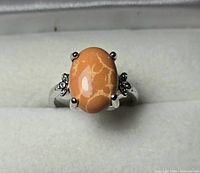 top view of ring showing orange cabochon and shoulder detailing