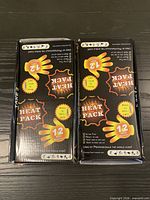 Two retail boxes closed, front graphics visible