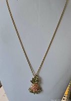 Full view of necklace on display bust showing chain length and pendant