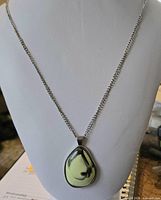 Front view showing entire necklace on display bust, pendant details and chain length