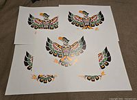 Five identical Thunderbird prints spread out on surface showing full design and paper size context