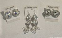All three pairs of rhinestone earrings on display cards