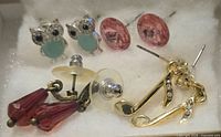 All four pairs of costume stud earrings in box