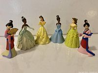 All six Disney Princess figurines standing in a row