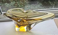 Side view of amber and clear freeform glass ashtray