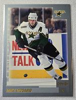 Front of Mike Modano O-Pee-Chee hockey card showing player image and logos