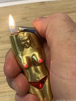 Lighter ignited showing red LED nipple lights and flame