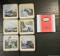 Six square coasters laid out next to original box
