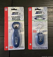 Front view of both sealed retail packages showing talking bottle opener and keychain