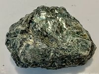 Green serpentine rock showing pearly sheen and matrix