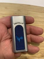 Front view of Sheng Feng lighter showing rooster motif