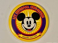Front view of the Disneyana Convention button showing design, colors, text and Mickey Mouse graphic