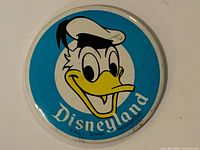 Front view of round Disneyland Donald Duck button