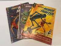 All three comic books fanned out showing covers