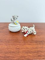 Front view of cat trinket box and Dalmatian figurine