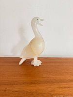 Front left view of carved onyx bird figurine showing overall form and color