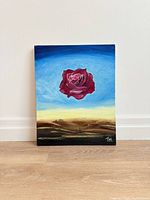 Front view of painting showing rose over desert landscape
