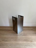 Full view of stainless-steel chimney extension standing upright