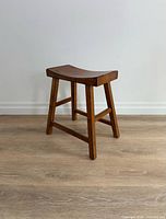 Full view of wooden stool angled front right