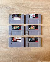 Six SNES cartridges laid out, front labels visible