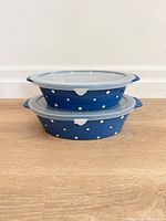 Two stacked covered baking dishes showing lids and size comparison