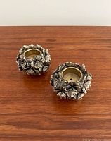 pair of floral silver-tone candle holders top view