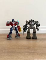 Front view of both Transformers figures standing upright on floor