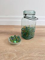 jar and small dish of marbles front view