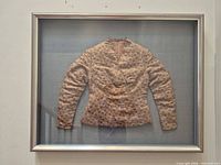 Front view of framed brocade bodice