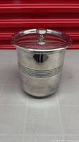 Ice bucket with lid showing stainless steel exterior and groove detail