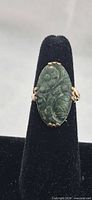 Front view of ring showing carved green oval stone and gold filled setting