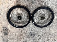 Two 26-inch wheels side by side showing tires and rear freewheel