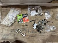 Overview of entire lot including hinges, fasteners, bulbs, tools