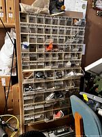 Full view of beige steel cabinet with many clear drawers