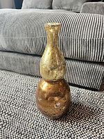 Full view of double-gourd glass vase on rug