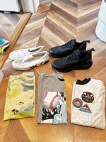 All items overview: two shoe pairs, three folded shirts
