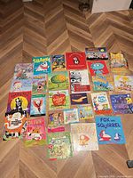 All 27 books laid out, showing variety of titles, formats and condition